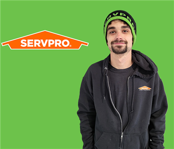 man in front of servpro logo