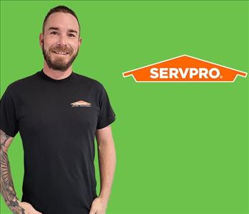 a man in front of a SERVPRO® background