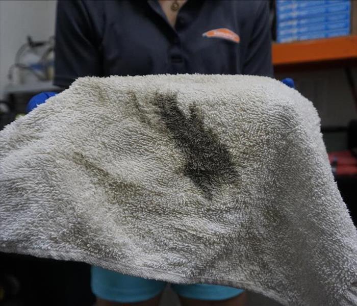 Towel containing a dark soot residue.